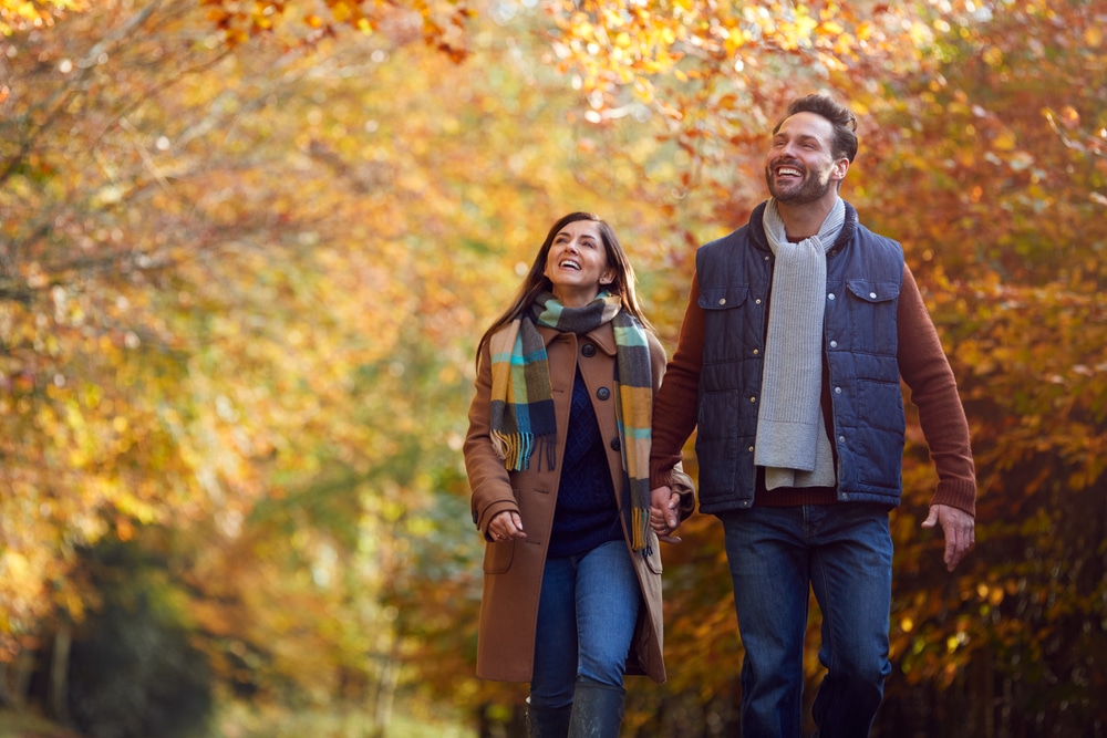 The Best Fall Weekend Getaways in PA Start Here! Happy couple on a walk in fall