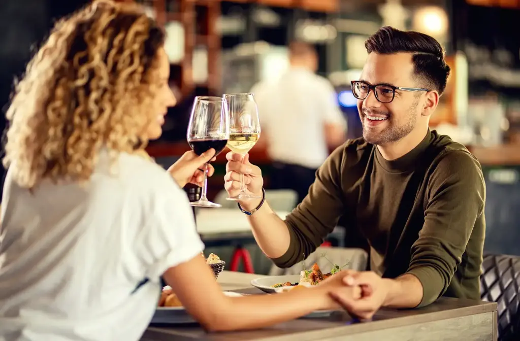 Couple toasting with red wine at a restaurant
